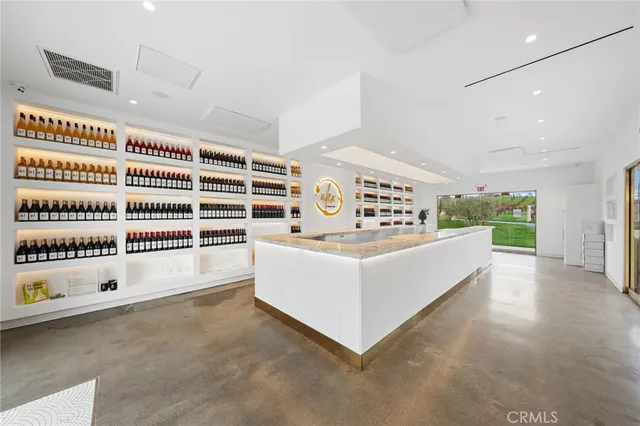 a living room with furniture a fireplace and a large window