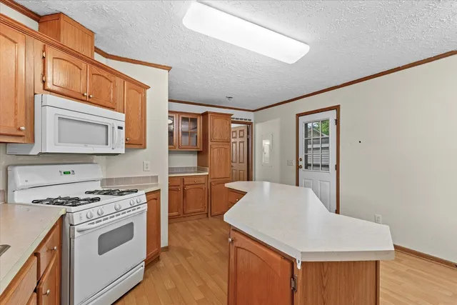a kitchen with stainless steel appliances a stove top oven