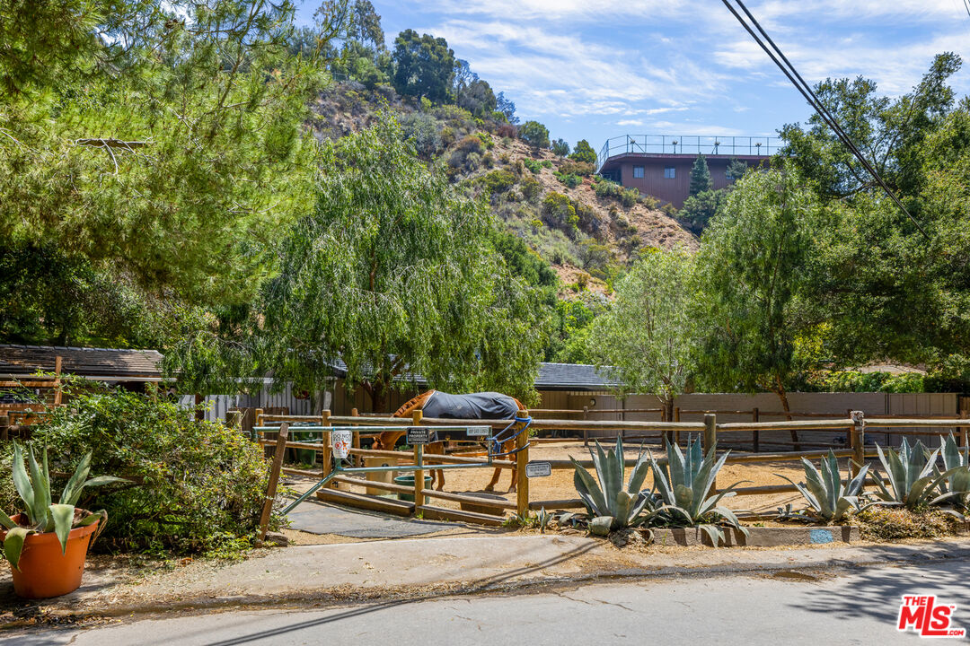 1776 Old Ranch Road Los Angeles, CA 90049 - Photo 19 of 20 a view of a chair and tables in the patio