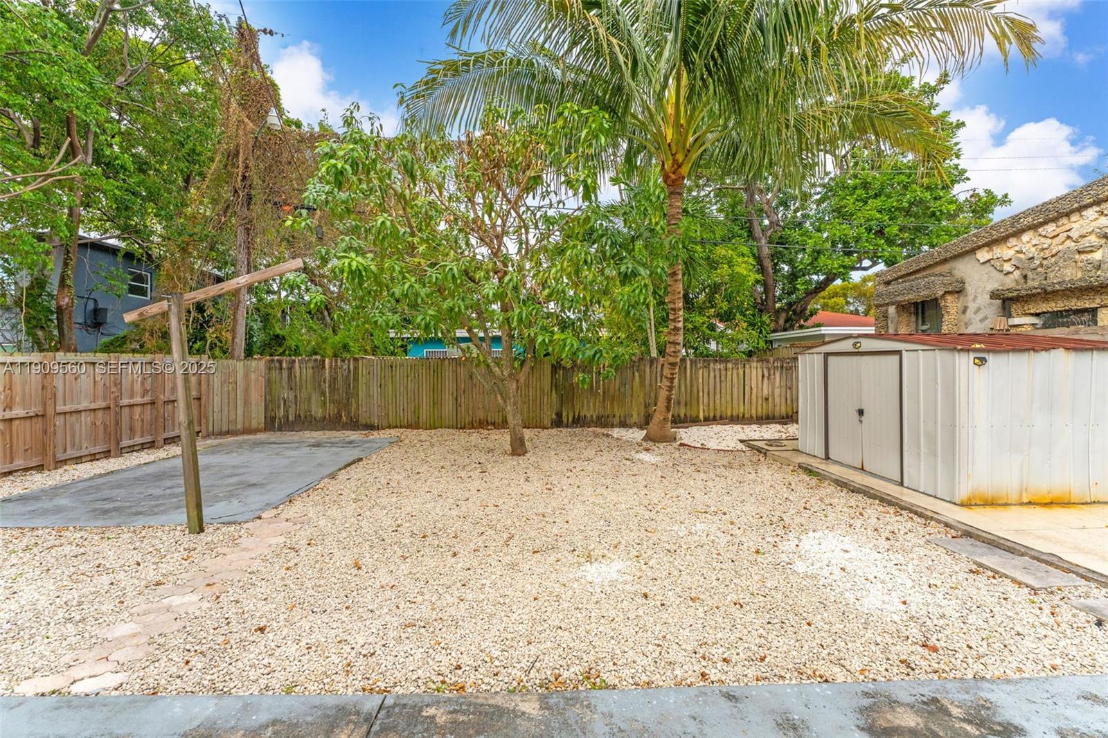 1621 Northwest 55th Street Miami, FL 33142 - Photo 17 of 24 a backyard of a house with a tree