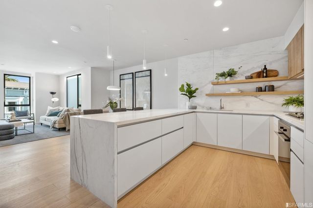a kitchen with a table a refrigerator and a stove