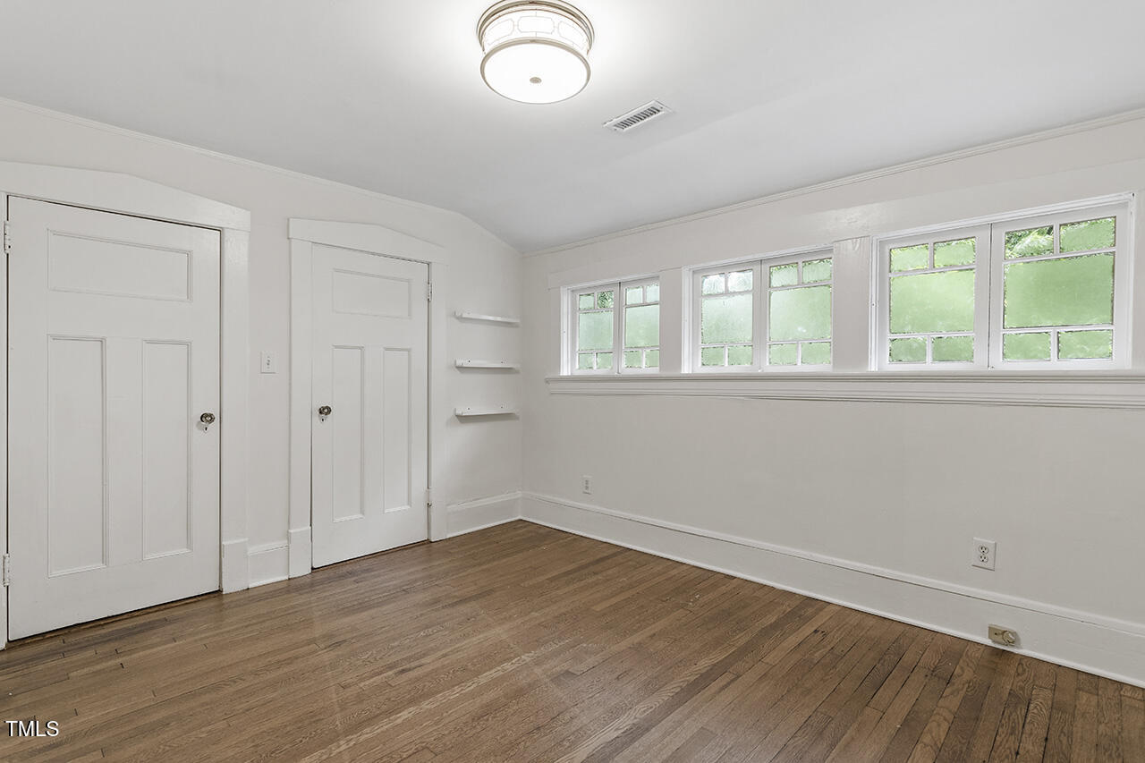 315 Polk Street Raleigh, NC 27604 - Photo 27 of 38 an empty room with wooden floor and windows