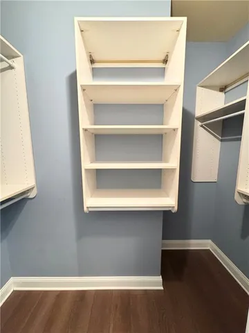 a view of a room with wooden floor and a window