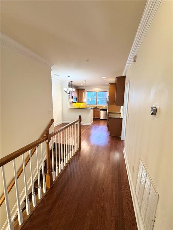 621 Perimeter Walk Atlanta, GA 30338 - Photo 4 of 20 a view of a hallway with wooden floor and furniture