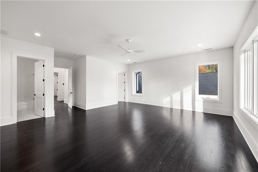 5211 Powers Ferry Road Northwest Sandy Springs, GA 30327 - Photo 93 of 106 a view of an empty room with wooden floor and a window