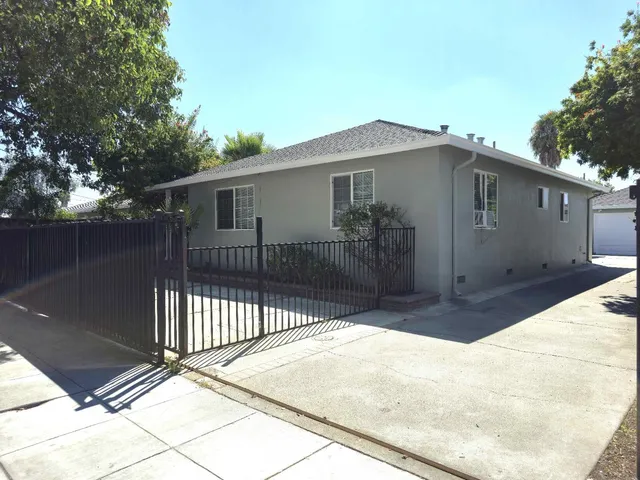 a side view of a house with a backyard