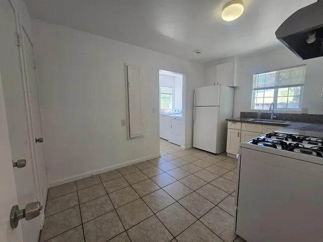 a kitchen with a sink a stove and refrigerator