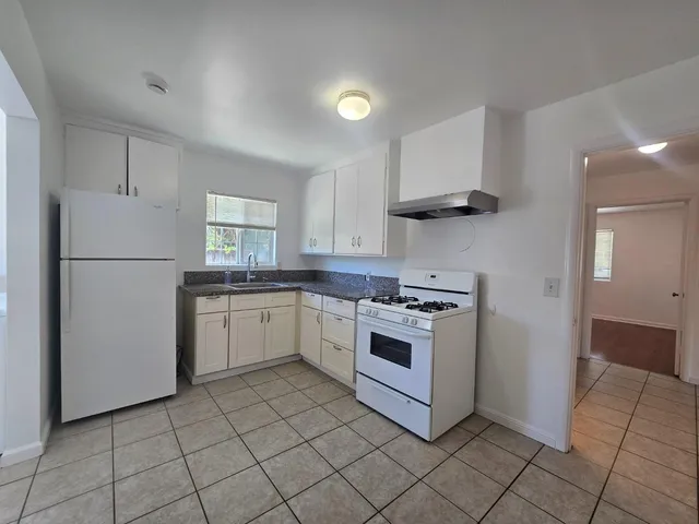 a kitchen with cabinets and white appliances