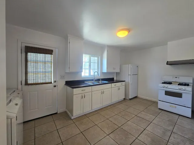 a kitchen with a stove a sink and a refrigerator