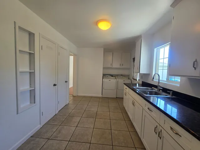 a kitchen with a sink and a stove top oven