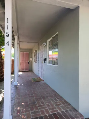 a view of a big room with wooden floor and windows