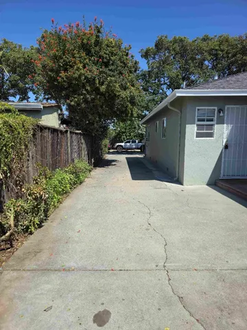 a view of backyard of house with green space
