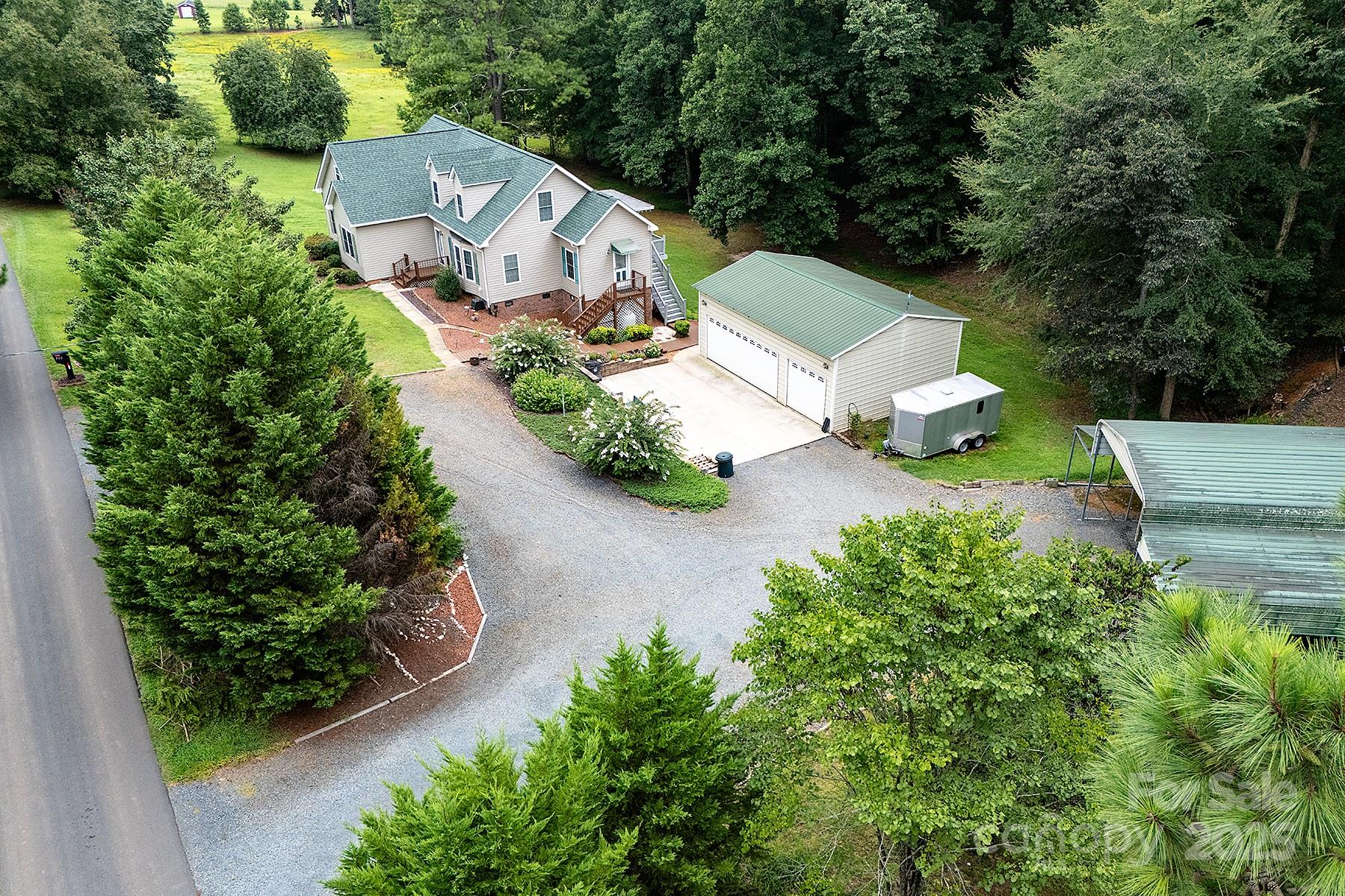 366 Lakehurst Farm Road Norwood, NC 28128 - Photo 1 of 46 an aerial view of a house with outdoor space and street view