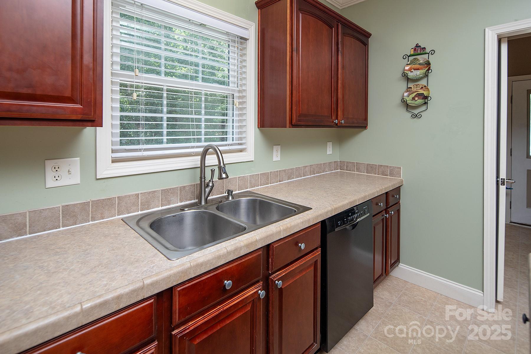 366 Lakehurst Farm Road Norwood, NC 28128 - Photo 11 of 46 a kitchen with a sink and cabinets
