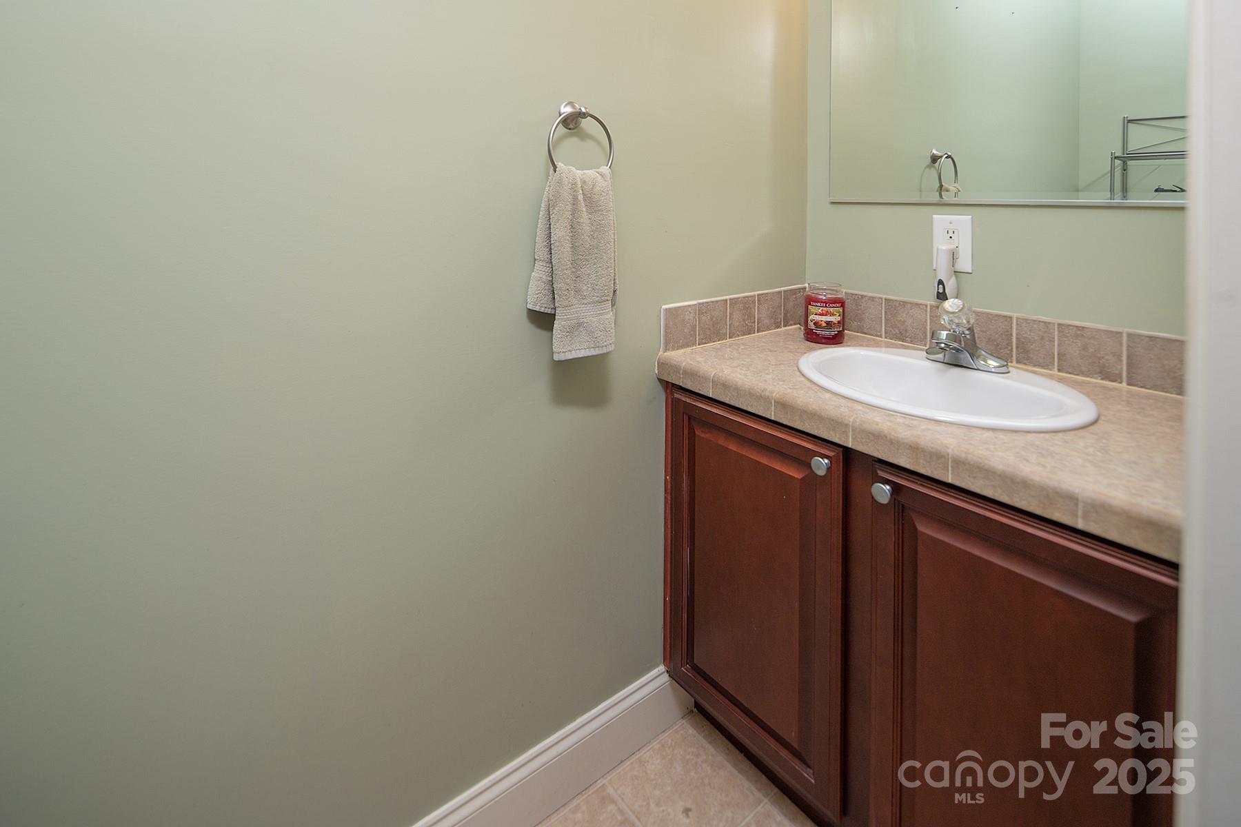 366 Lakehurst Farm Road Norwood, NC 28128 - Photo 12 of 46 a bathroom with a sink and a mirror