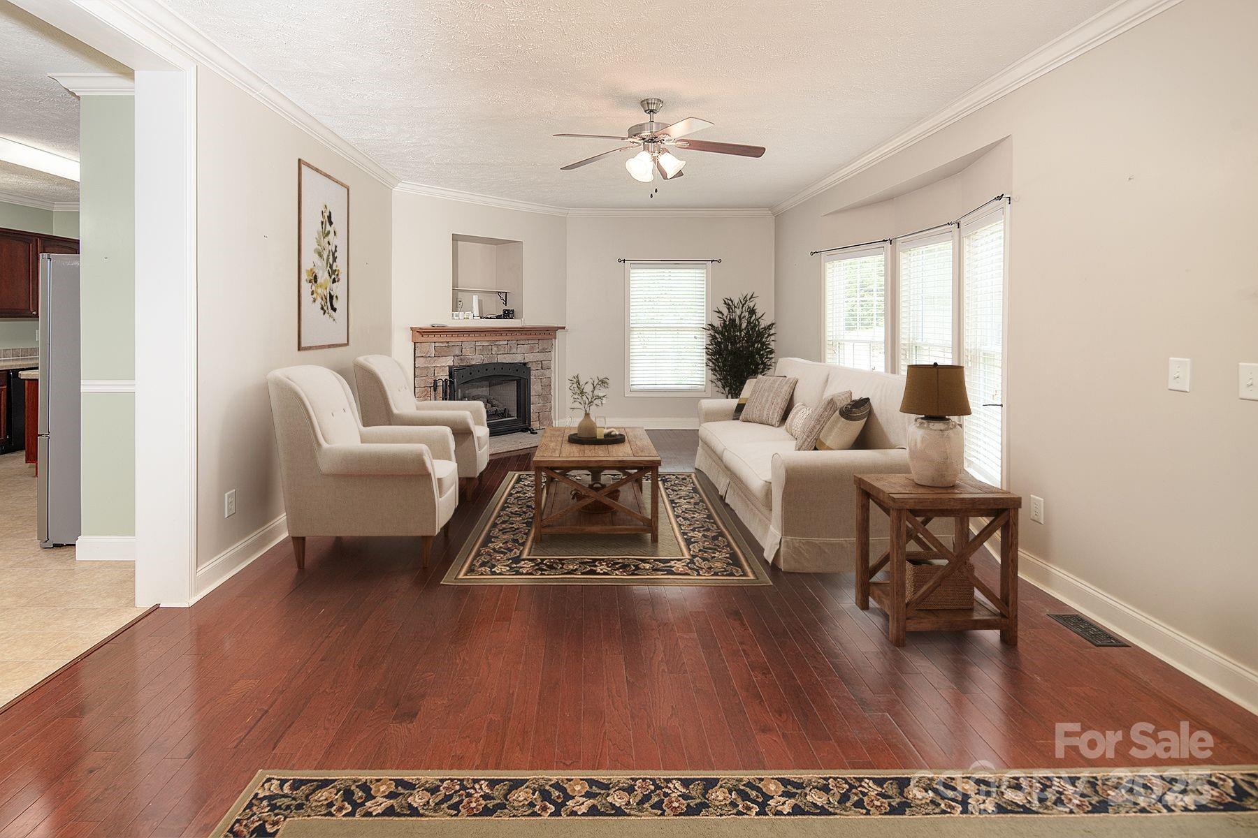 366 Lakehurst Farm Road Norwood, NC 28128 - Photo 16 of 46 a living room with furniture dining table and a fireplace