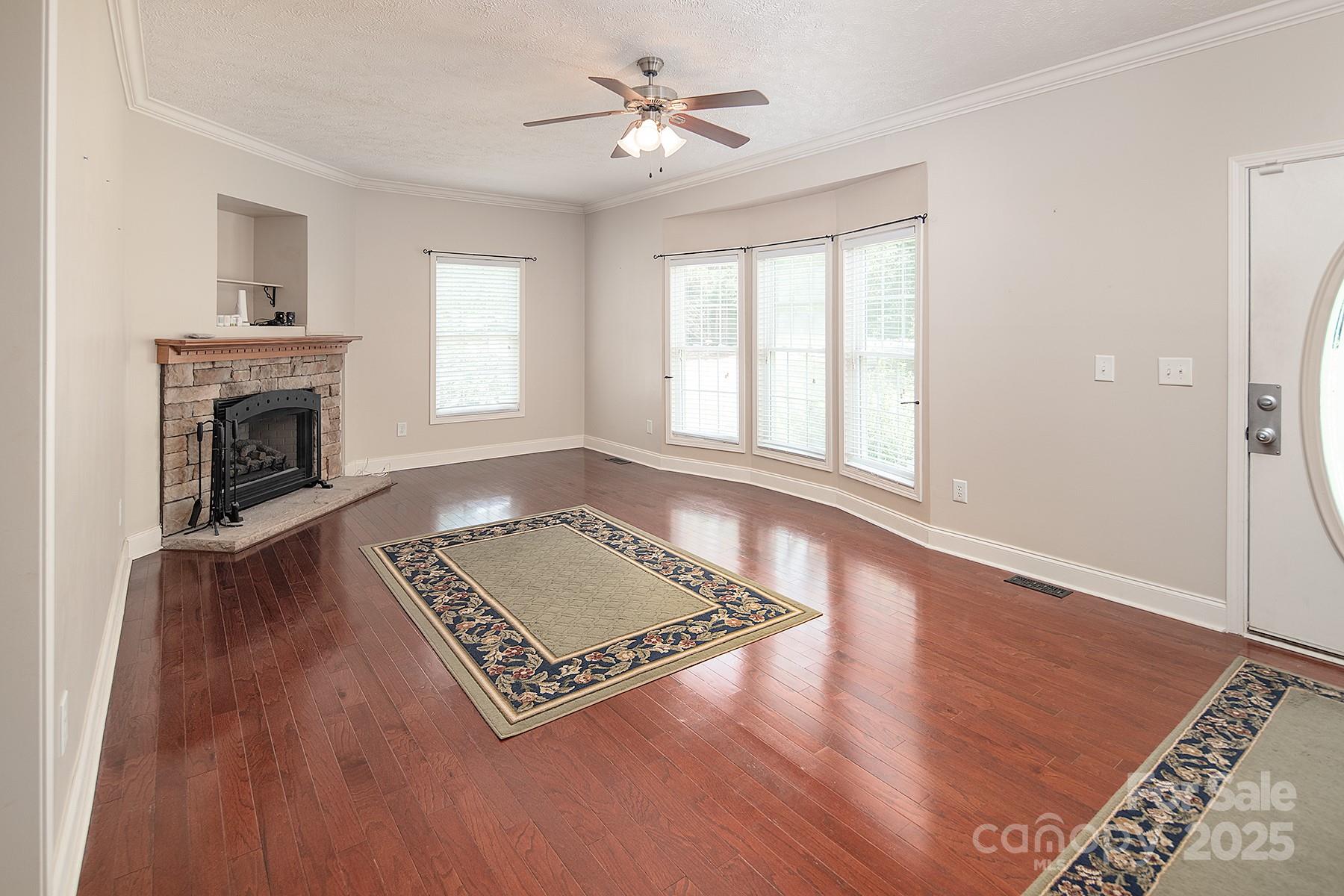 366 Lakehurst Farm Road Norwood, NC 28128 - Photo 19 of 46 a living room with hard wood floors and a fireplace