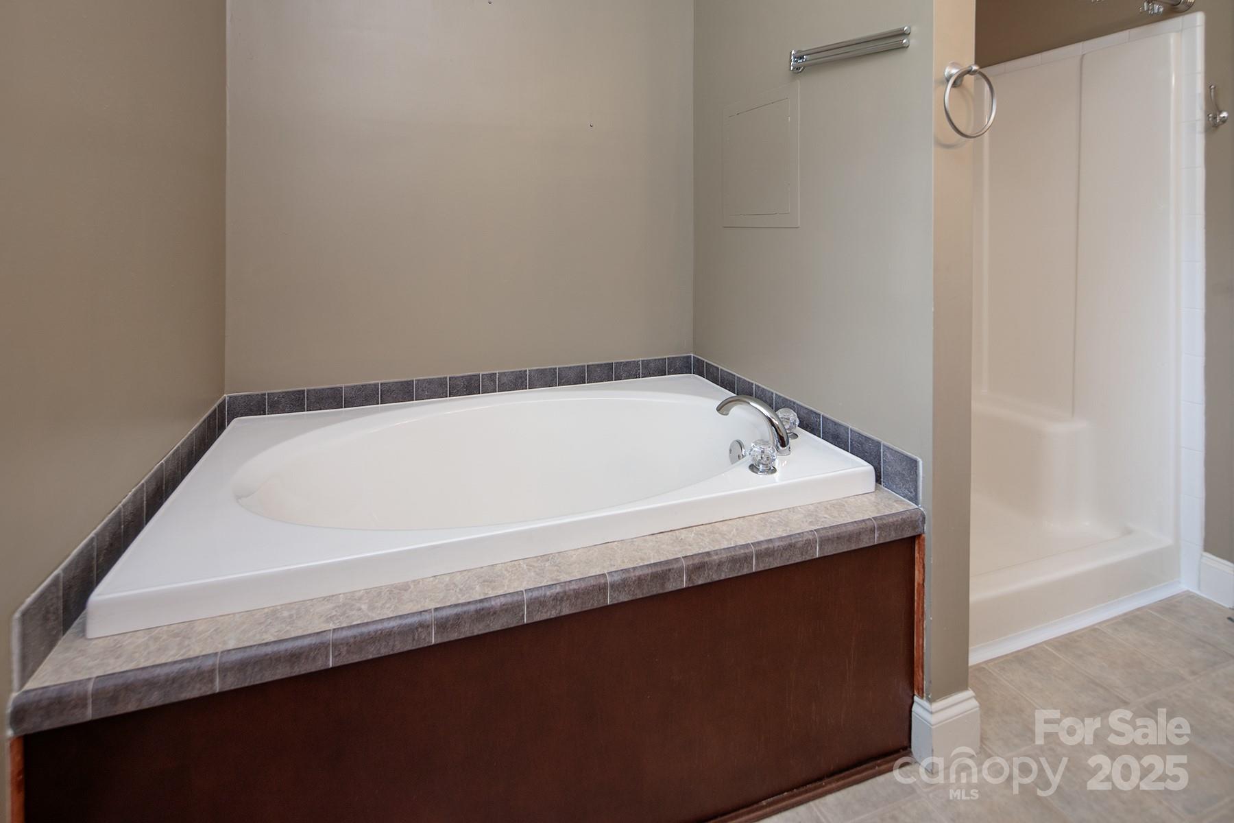 366 Lakehurst Farm Road Norwood, NC 28128 - Photo 27 of 46 a close up of a bathtub in a bathroom