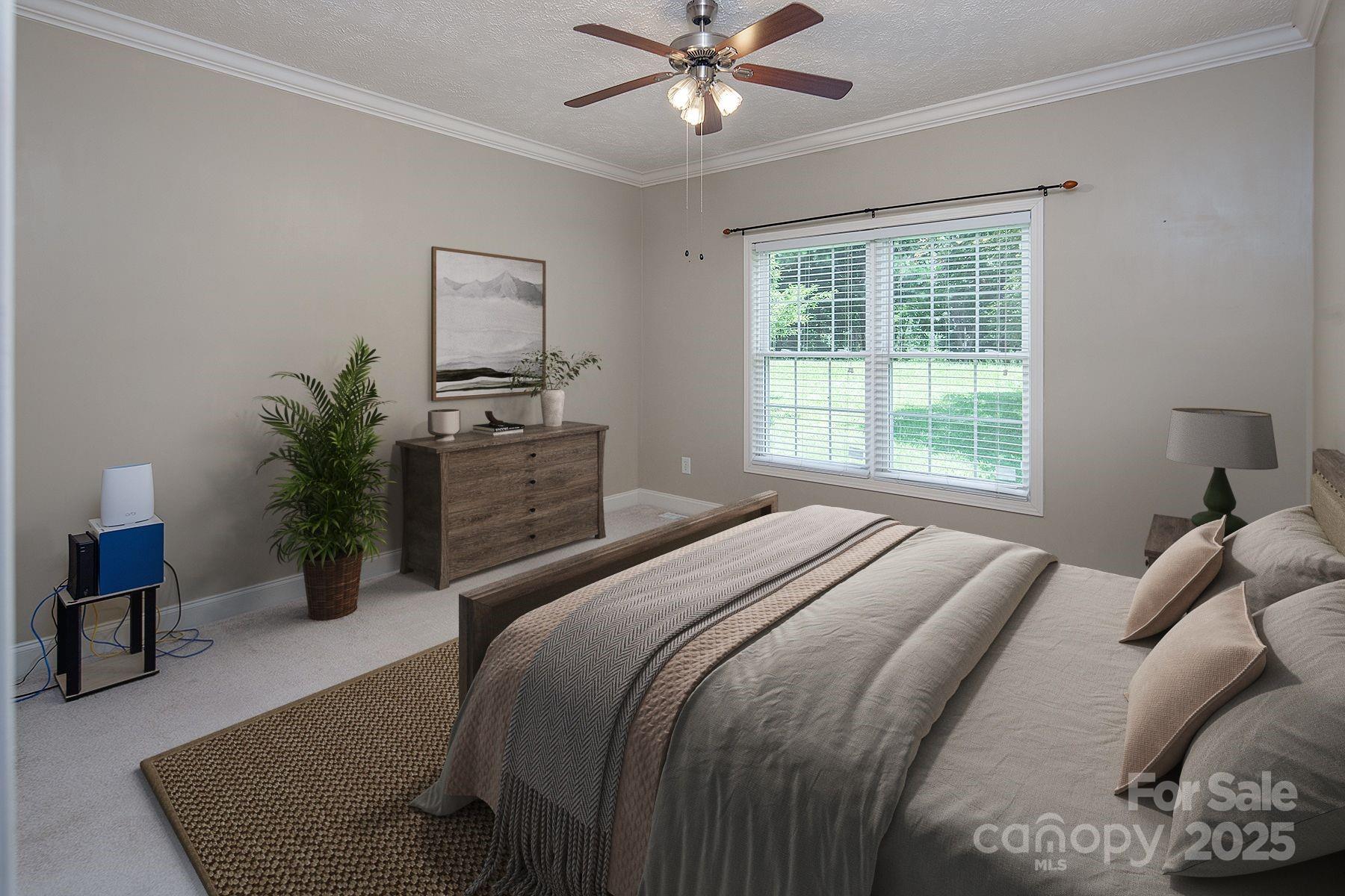 366 Lakehurst Farm Road Norwood, NC 28128 - Photo 28 of 46 a bedroom with a bed and a chandelier