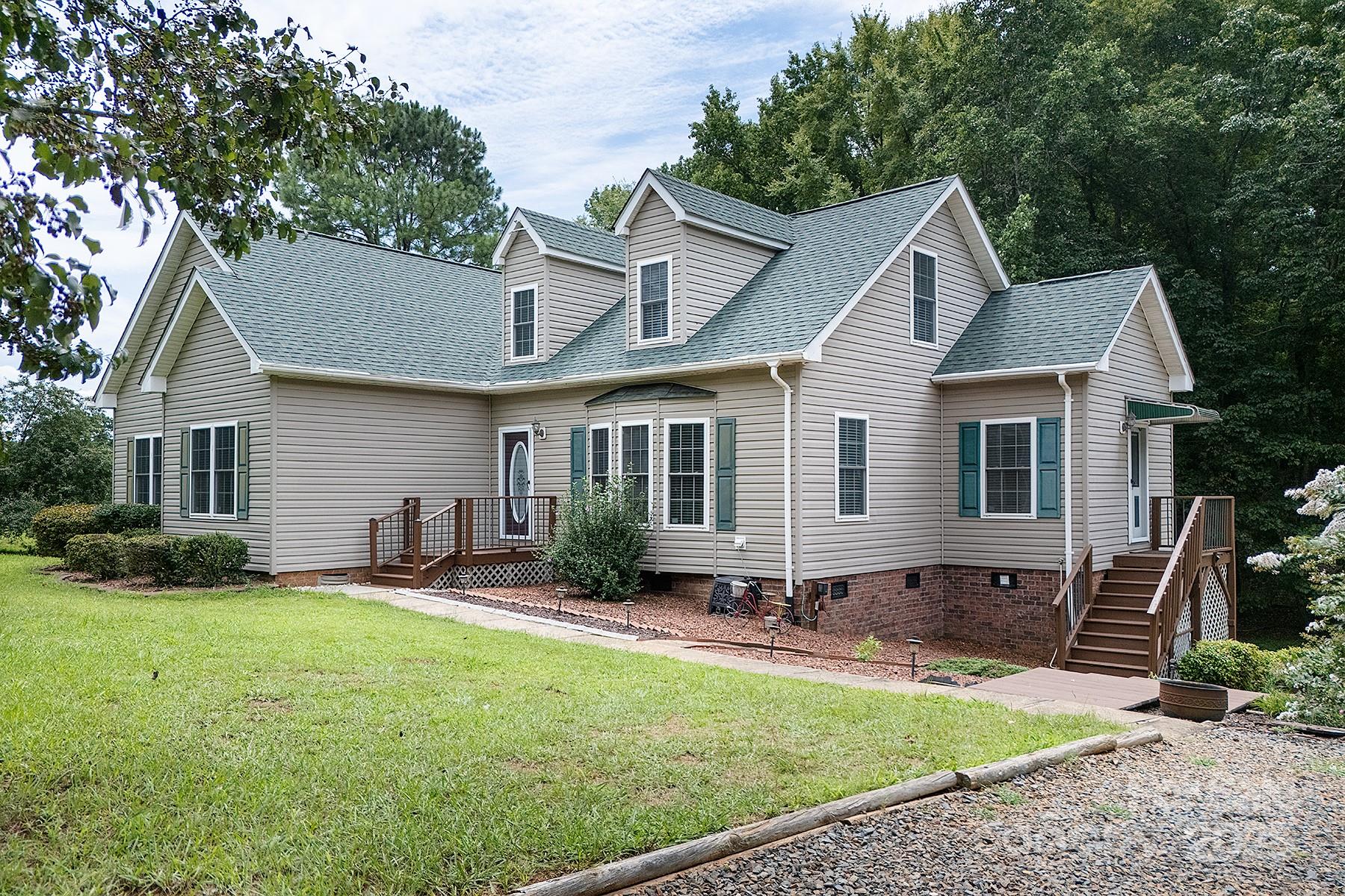 366 Lakehurst Farm Road Norwood, NC 28128 - Photo 3 of 46 a front view of a house with garden