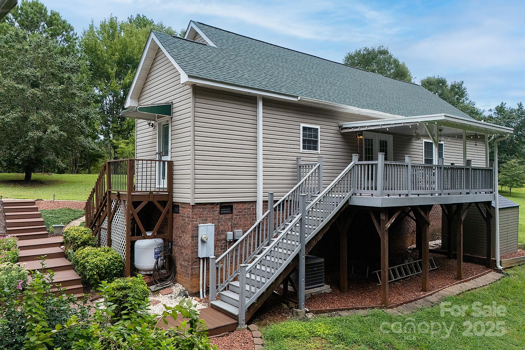 366 Lakehurst Farm Road Norwood, NC 28128 - Photo 37 of 46 a front view of a house with garden