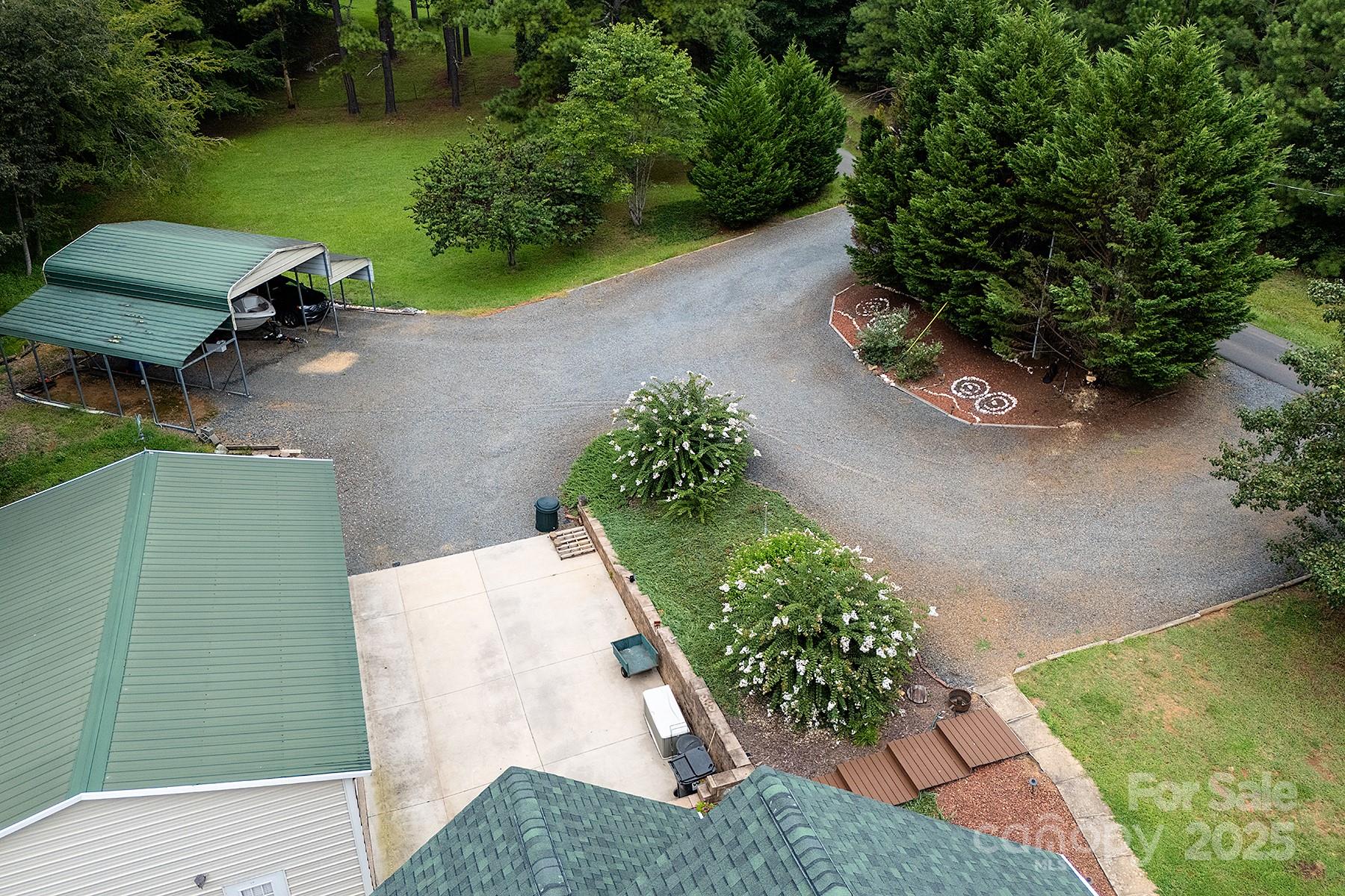 366 Lakehurst Farm Road Norwood, NC 28128 - Photo 44 of 46 a view of a backyard with table and chairs potted plants