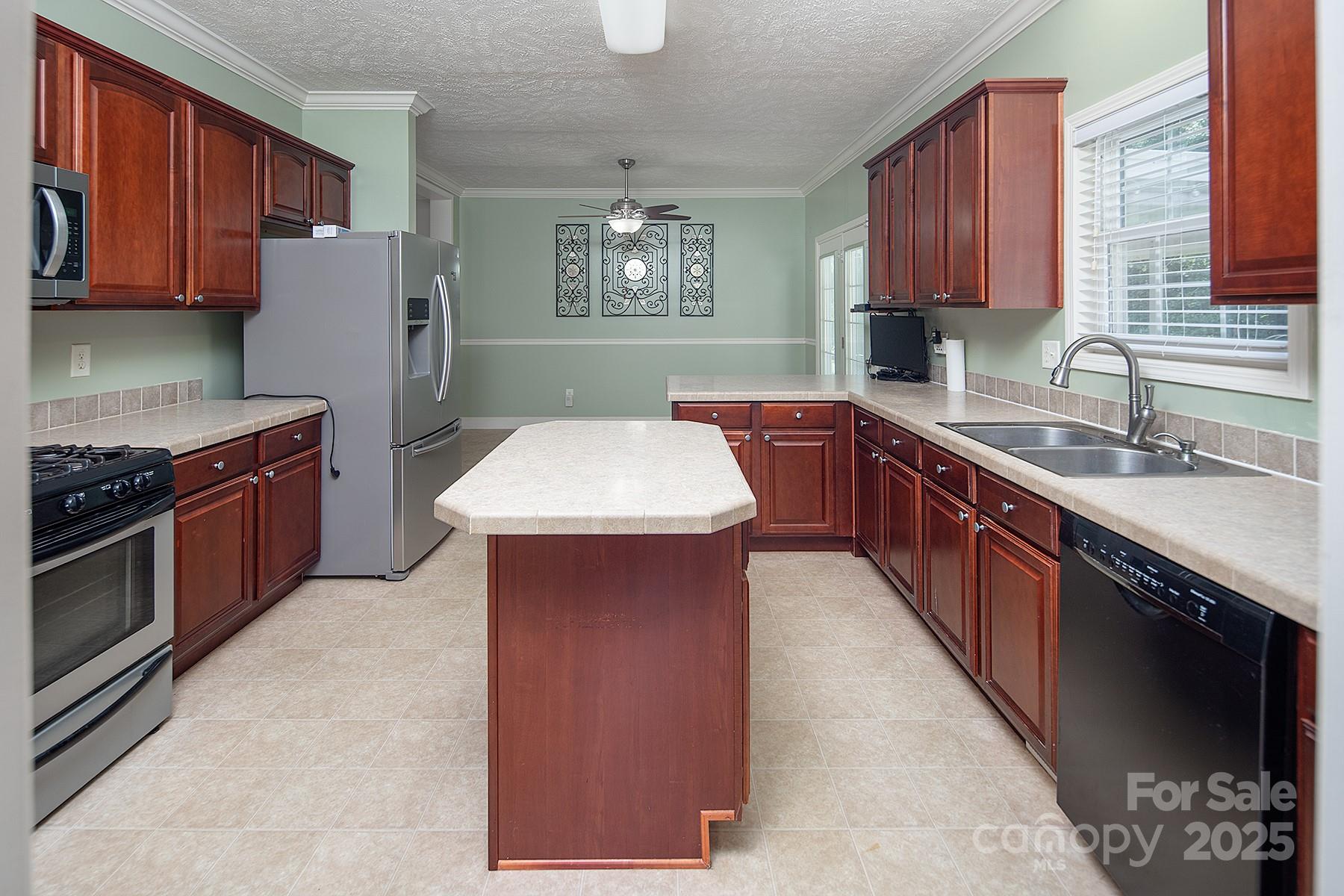 366 Lakehurst Farm Road Norwood, NC 28128 - Photo 10 of 46 a kitchen with stainless steel appliances granite countertop a sink stove and refrigerator