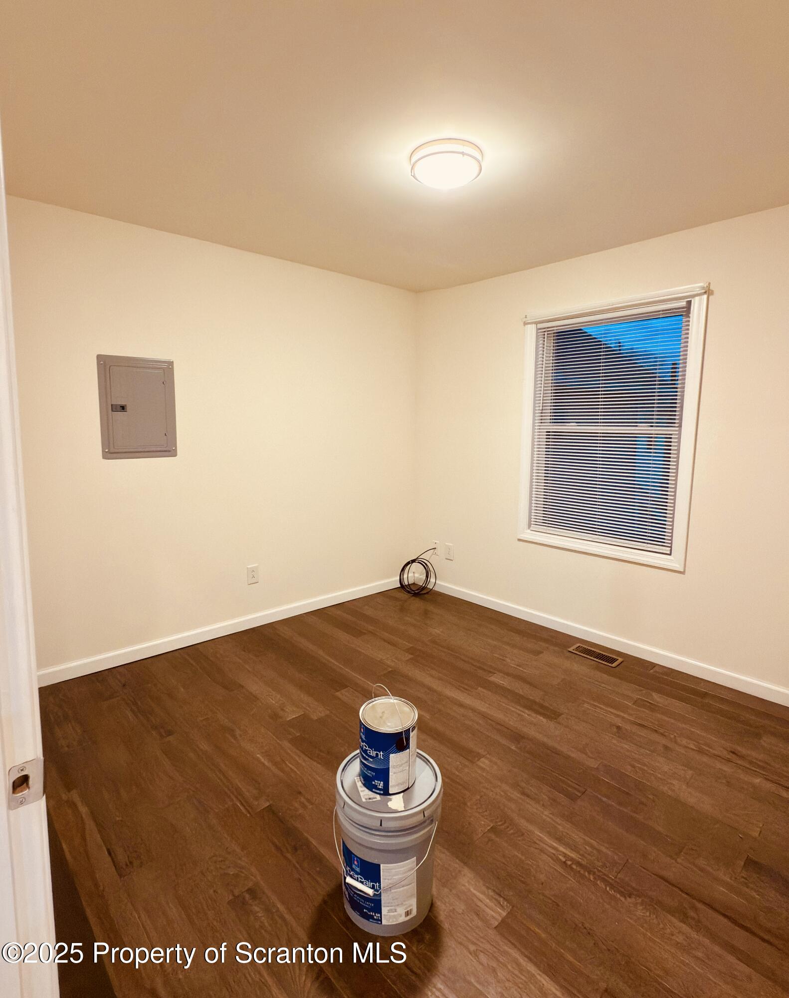 3709 Laurel Avenue, Unit REAR 2 Moosic, PA 18507 - Photo 11 of 12 a room with a wooden floor and a potted plant