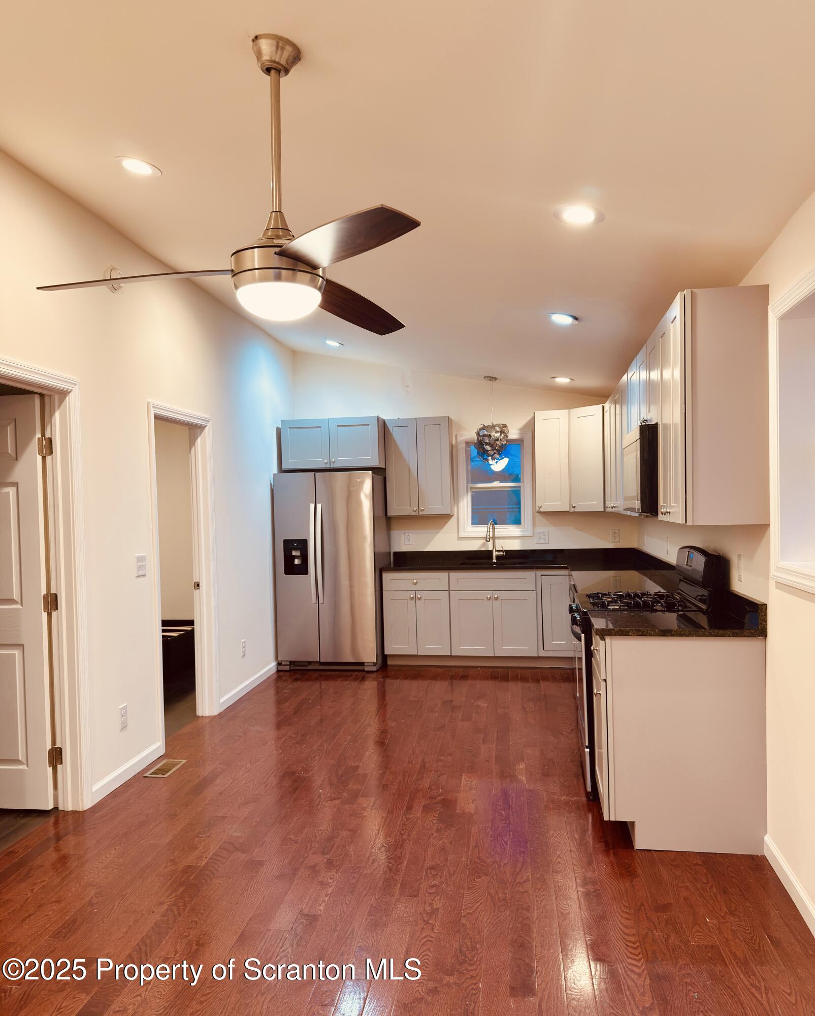 3709 Laurel Avenue, Unit REAR 2 Moosic, PA 18507 - Photo 3 of 12 a kitchen with stainless steel appliances granite countertop a refrigerator a sink and a stove