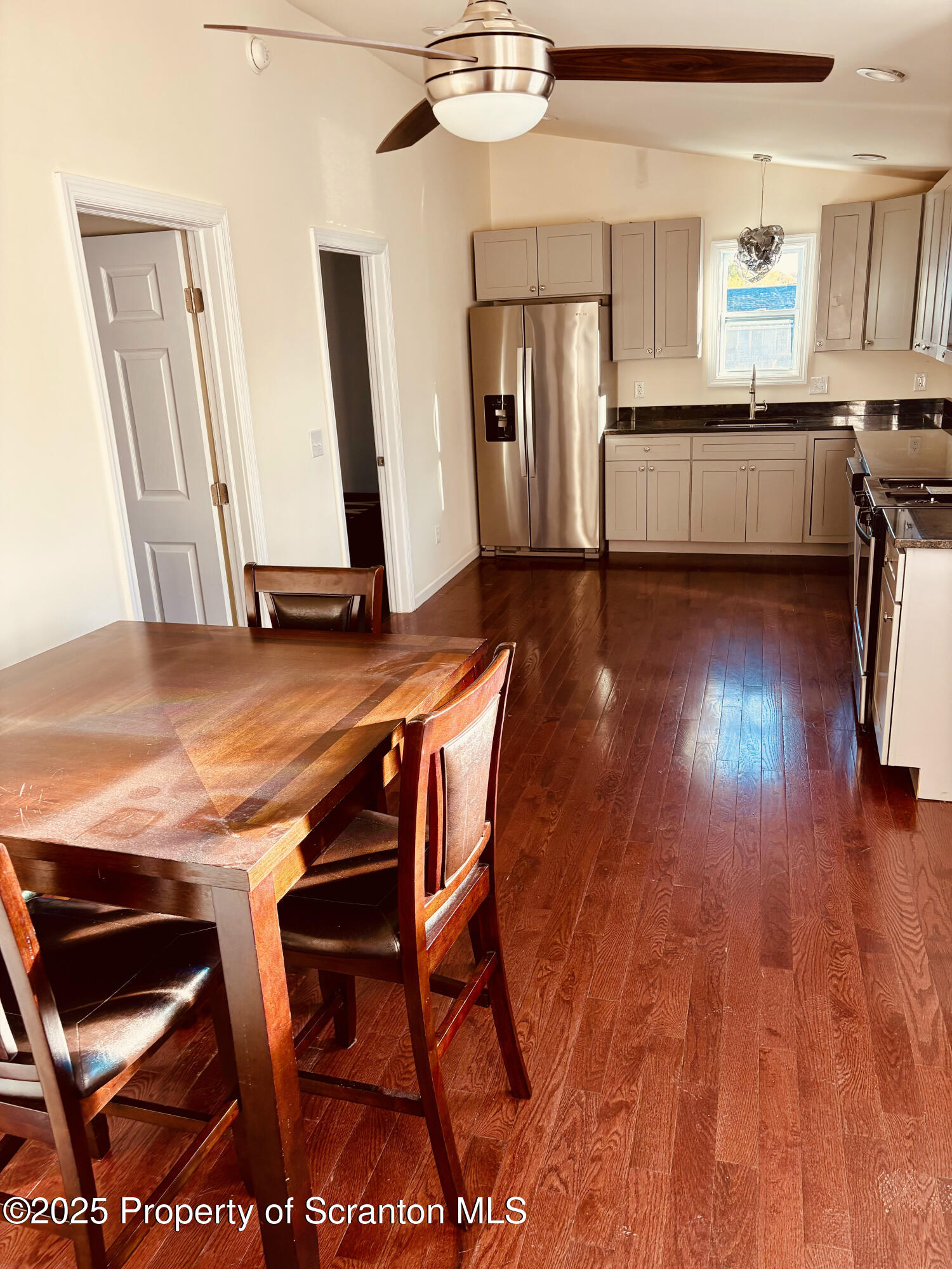 3709 Laurel Avenue, Unit REAR 2 Moosic, PA 18507 - Photo 5 of 12 a living room with stainless steel appliances kitchen island granite countertop furniture and a wooden floor