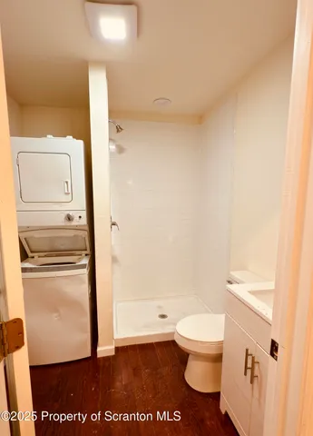 a bathroom with a shower toilet and sink