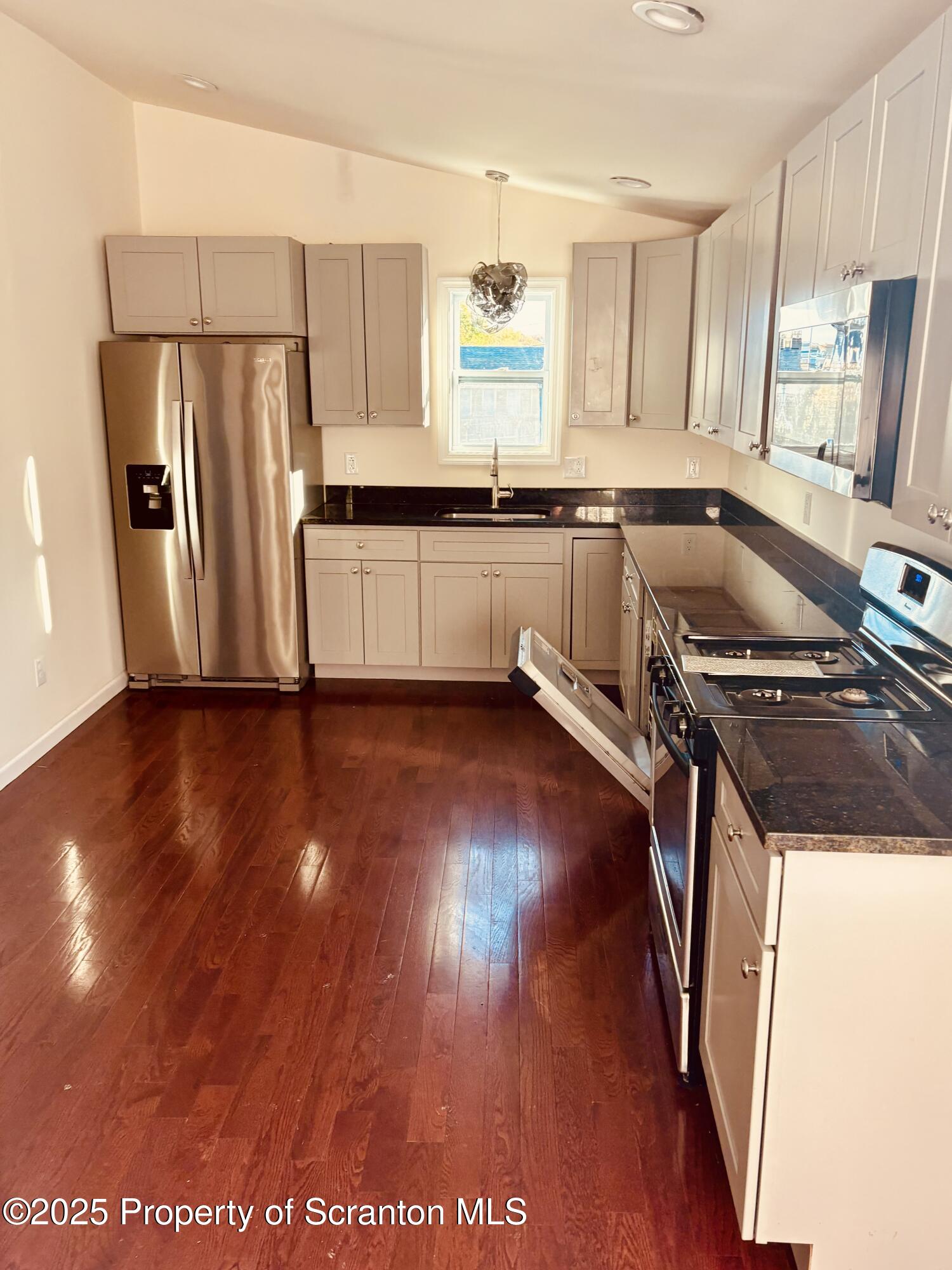 3709 Laurel Avenue, Unit REAR 2 Moosic, PA 18507 - Photo 8 of 12 a kitchen with a refrigerator and a stove