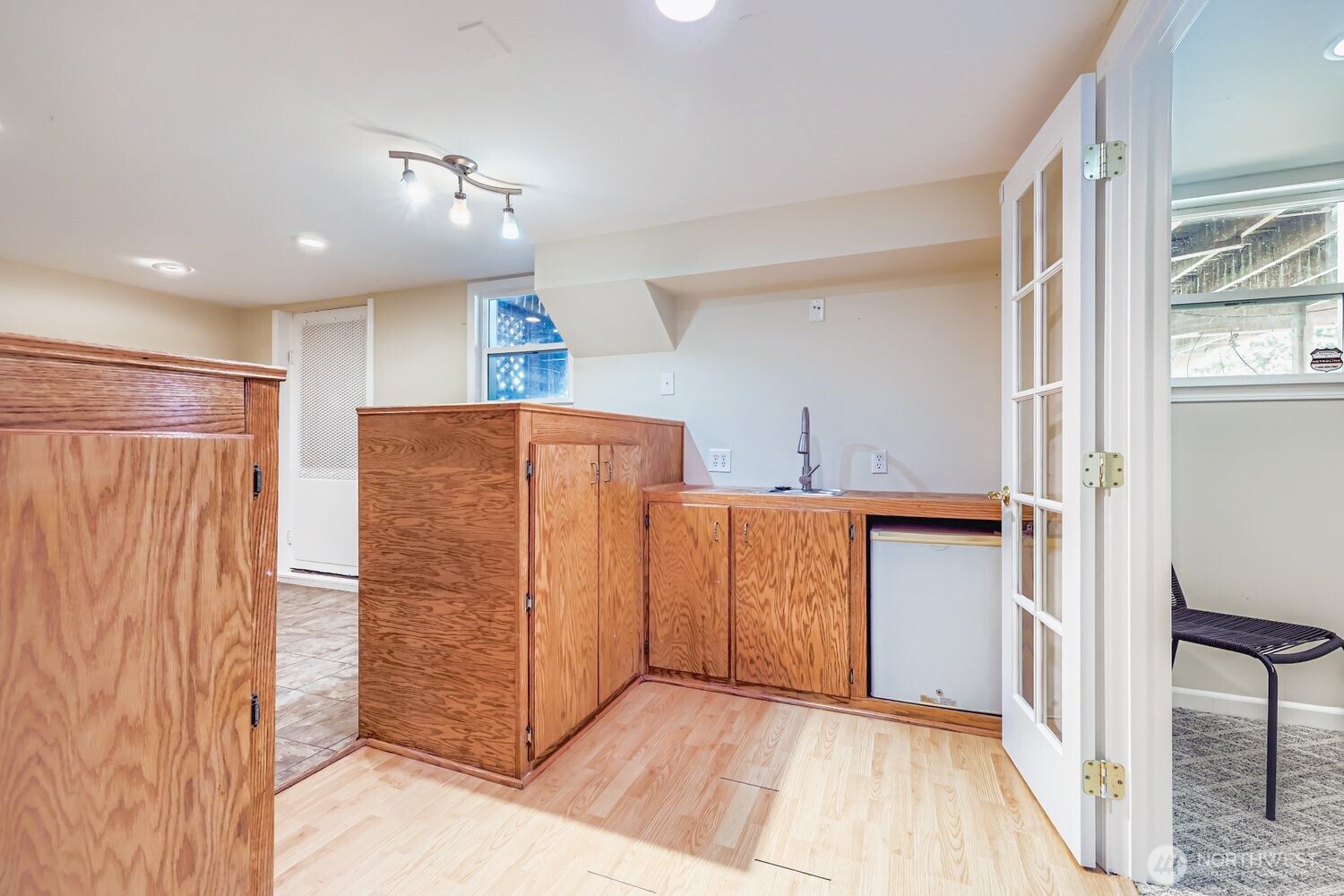 23001 Brier Road Brier, WA 98036 - Photo 23 of 28 a view of hallway with cabinets and wooden floor