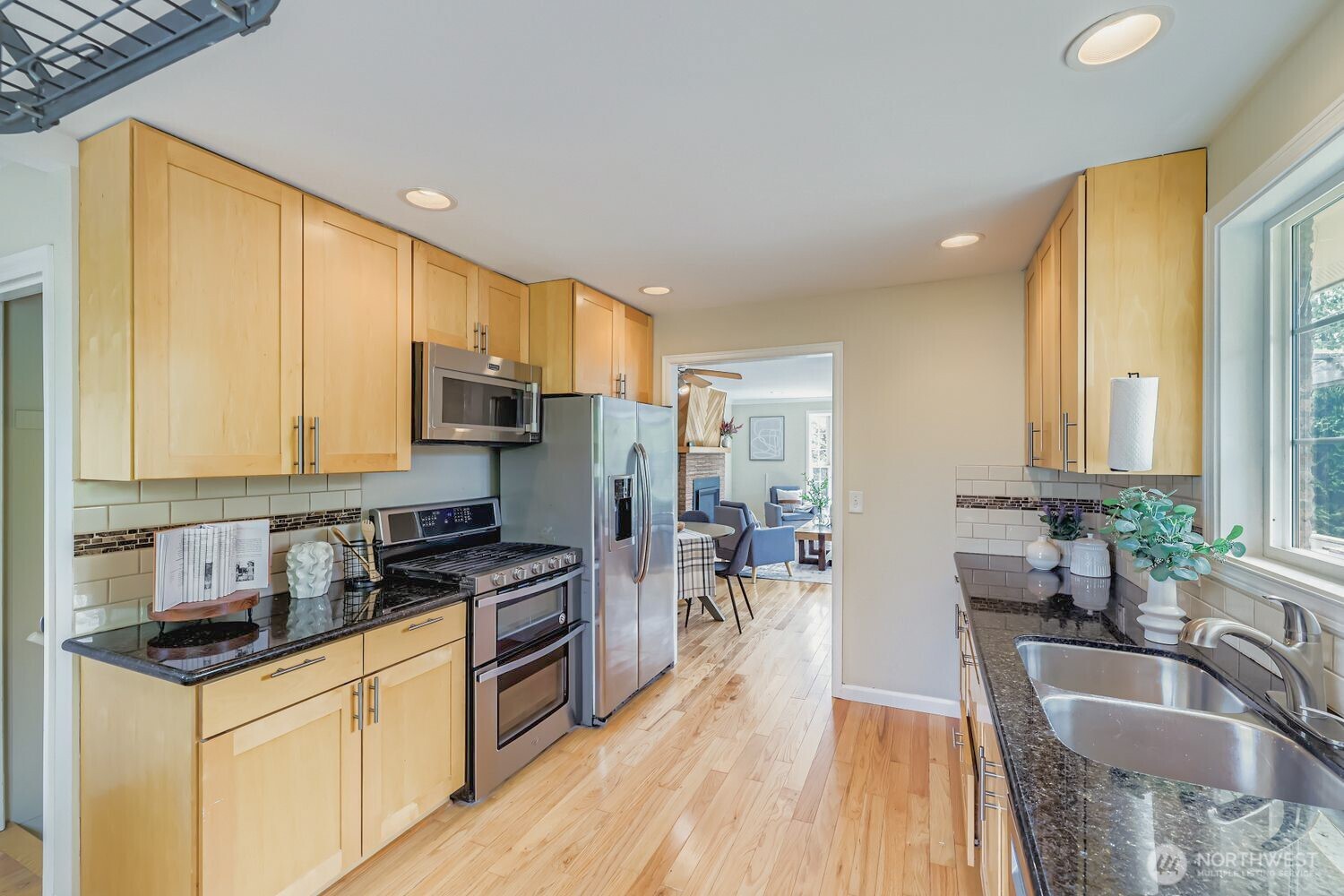 23001 Brier Road Brier, WA 98036 - Photo 9 of 28 a kitchen with granite countertop a sink a counter top space appliances and cabinets