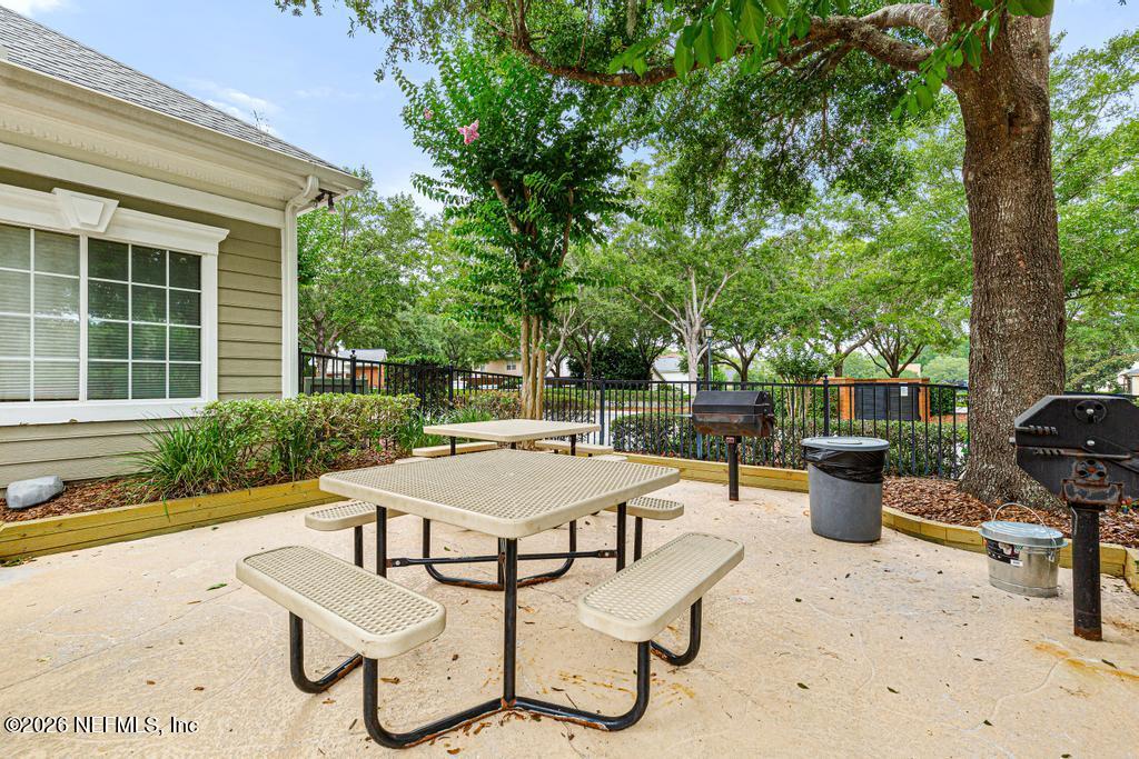 7843 Mt Ranier Drive Jacksonville, FL 32256 - Photo 112 of 116 a table and chairs sitting in front of a house