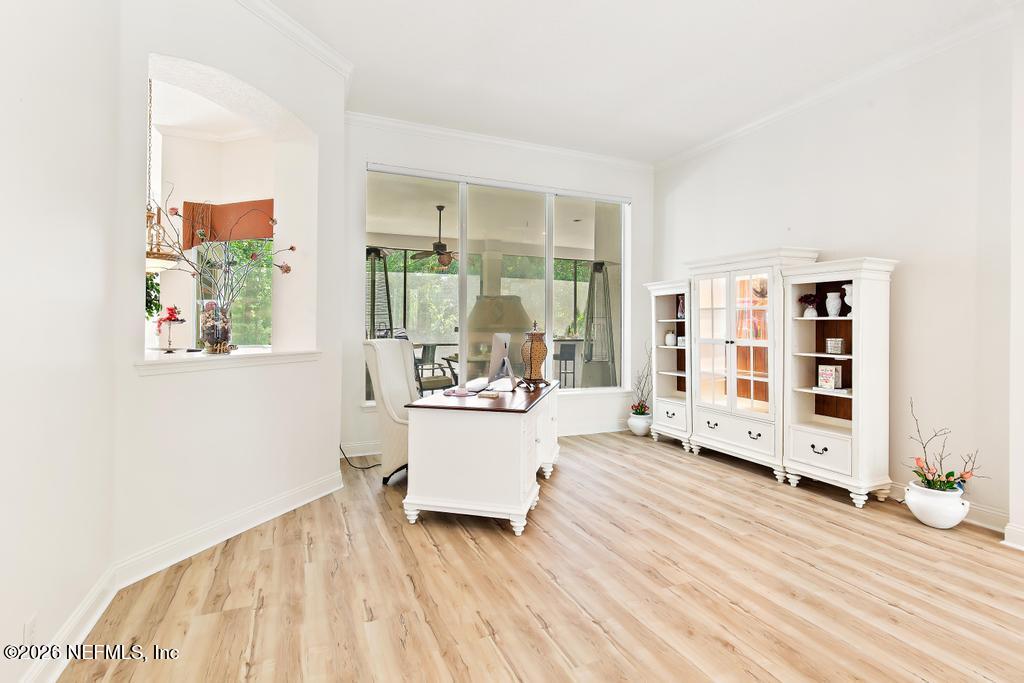 7843 Mt Ranier Drive Jacksonville, FL 32256 - Photo 21 of 116 a living room with furniture and a floor to ceiling window