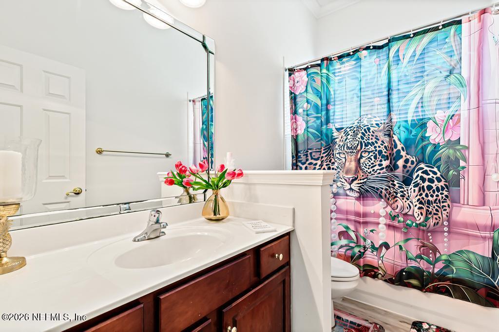 7843 Mt Ranier Drive Jacksonville, FL 32256 - Photo 23 of 116 a bathroom with a sink mirror and window