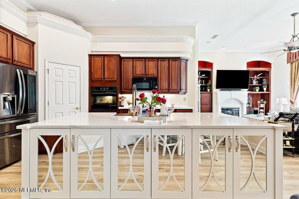 7843 Mt Ranier Drive Jacksonville, FL 32256 - Photo 30 of 116 a kitchen with a stove a sink and a refrigerator