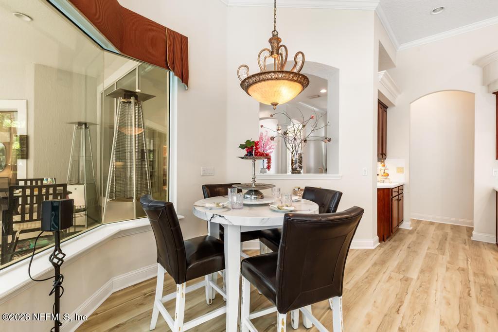 7843 Mt Ranier Drive Jacksonville, FL 32256 - Photo 36 of 116 a view of a dining room with furniture and wooden floor