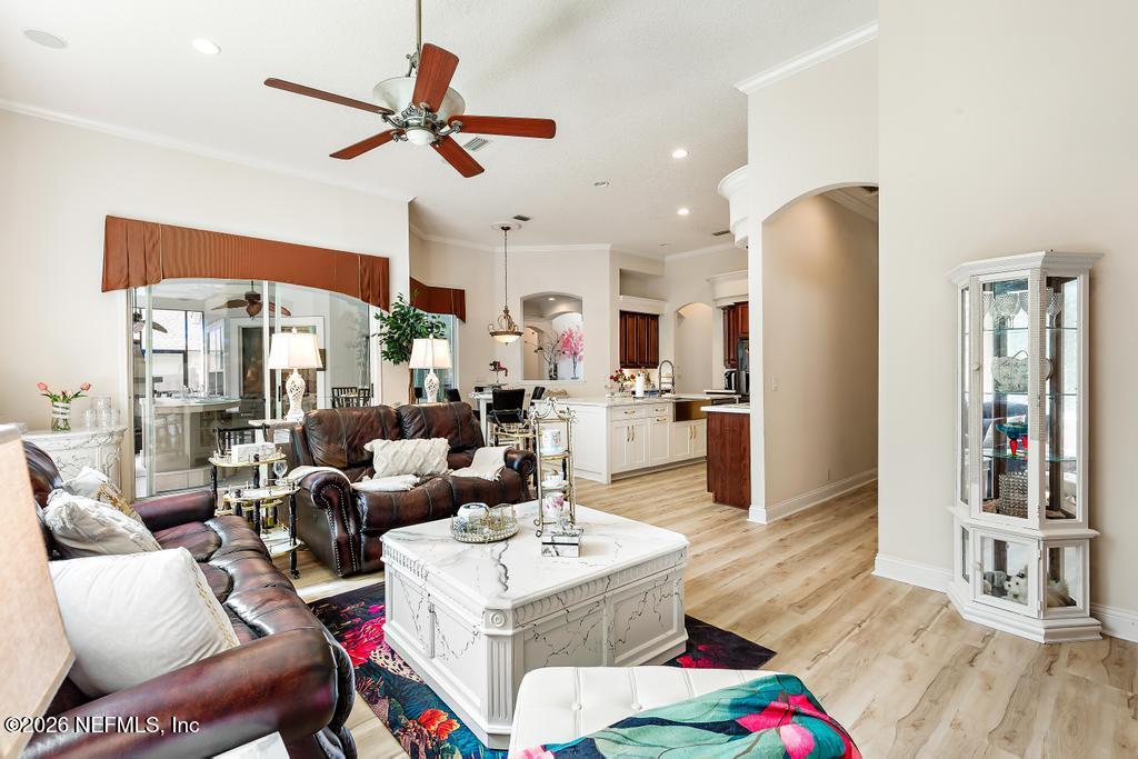 7843 Mt Ranier Drive Jacksonville, FL 32256 - Photo 41 of 116 a living room with furniture kitchen view and a large window