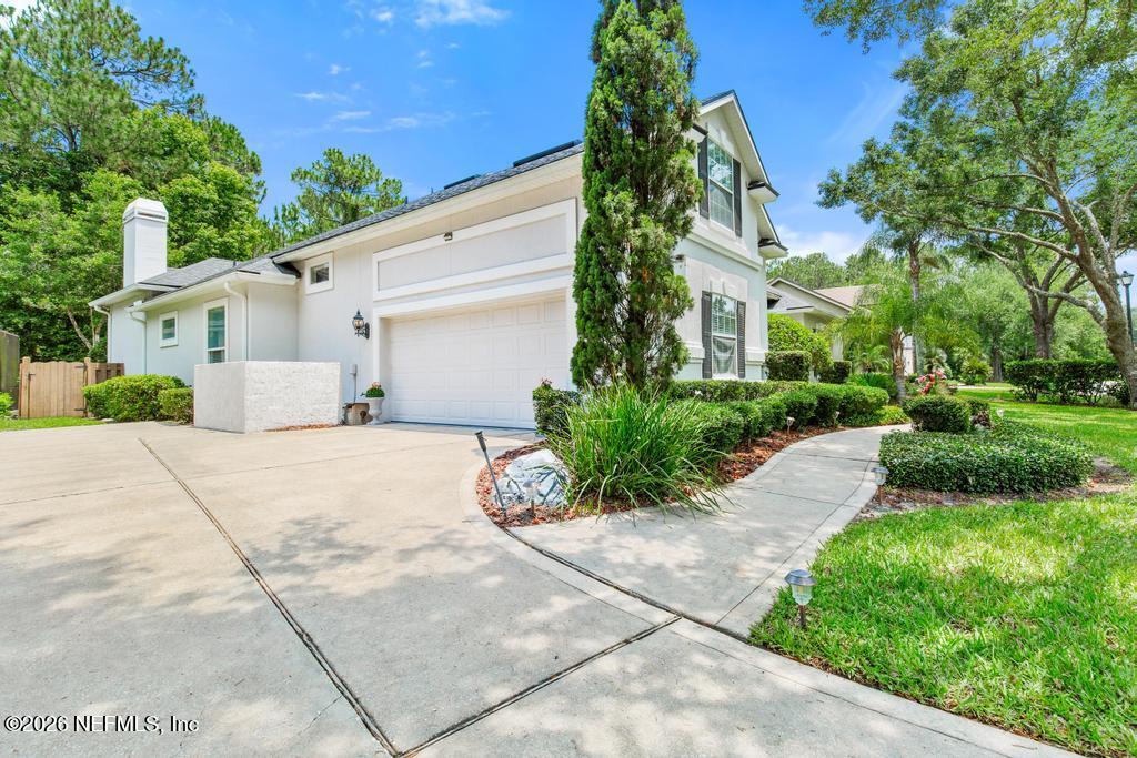7843 Mt Ranier Drive Jacksonville, FL 32256 - Photo 5 of 116 a front view of a house with a yard and potted plants