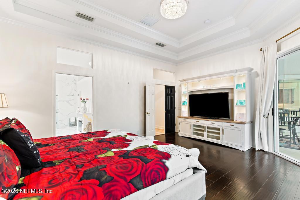 7843 Mt Ranier Drive Jacksonville, FL 32256 - Photo 53 of 116 a bedroom with a bed and a flat screen tv