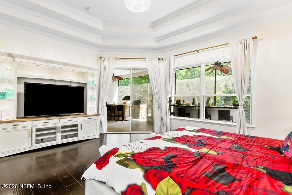 7843 Mt Ranier Drive Jacksonville, FL 32256 - Photo 54 of 116 a bedroom with a bed and a flat screen tv