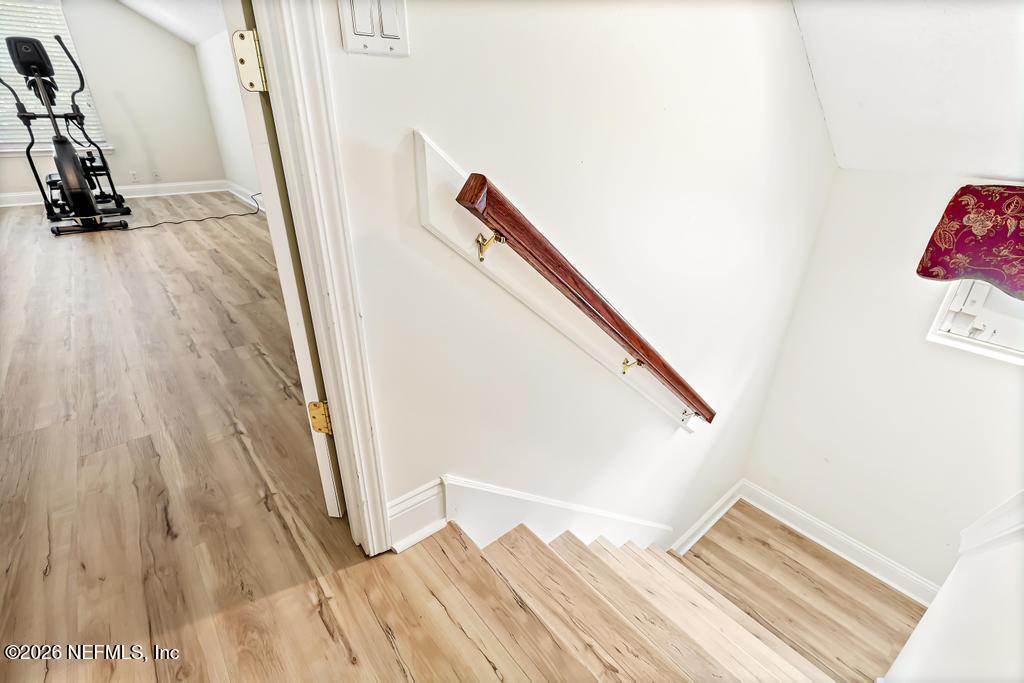 7843 Mt Ranier Drive Jacksonville, FL 32256 - Photo 65 of 116 a view of a hallway with wooden floor and stairs