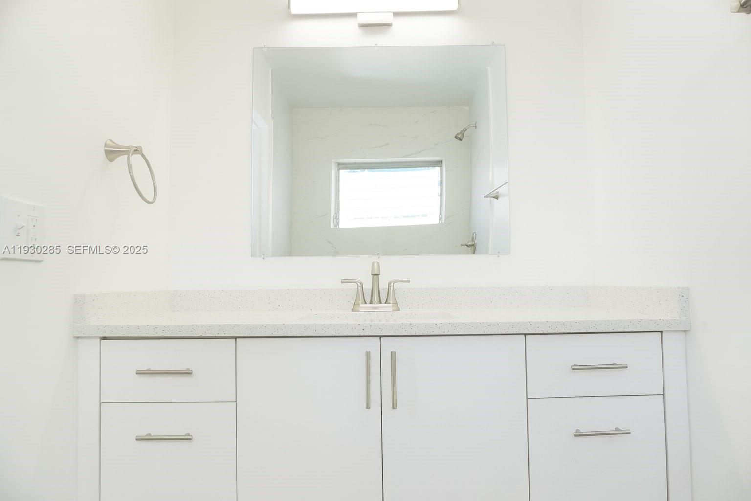 749 Southeast 15th Street, Unit 10 Fort Lauderdale, FL 33316 - Photo 12 of 16 a bathroom with a sink and a mirror