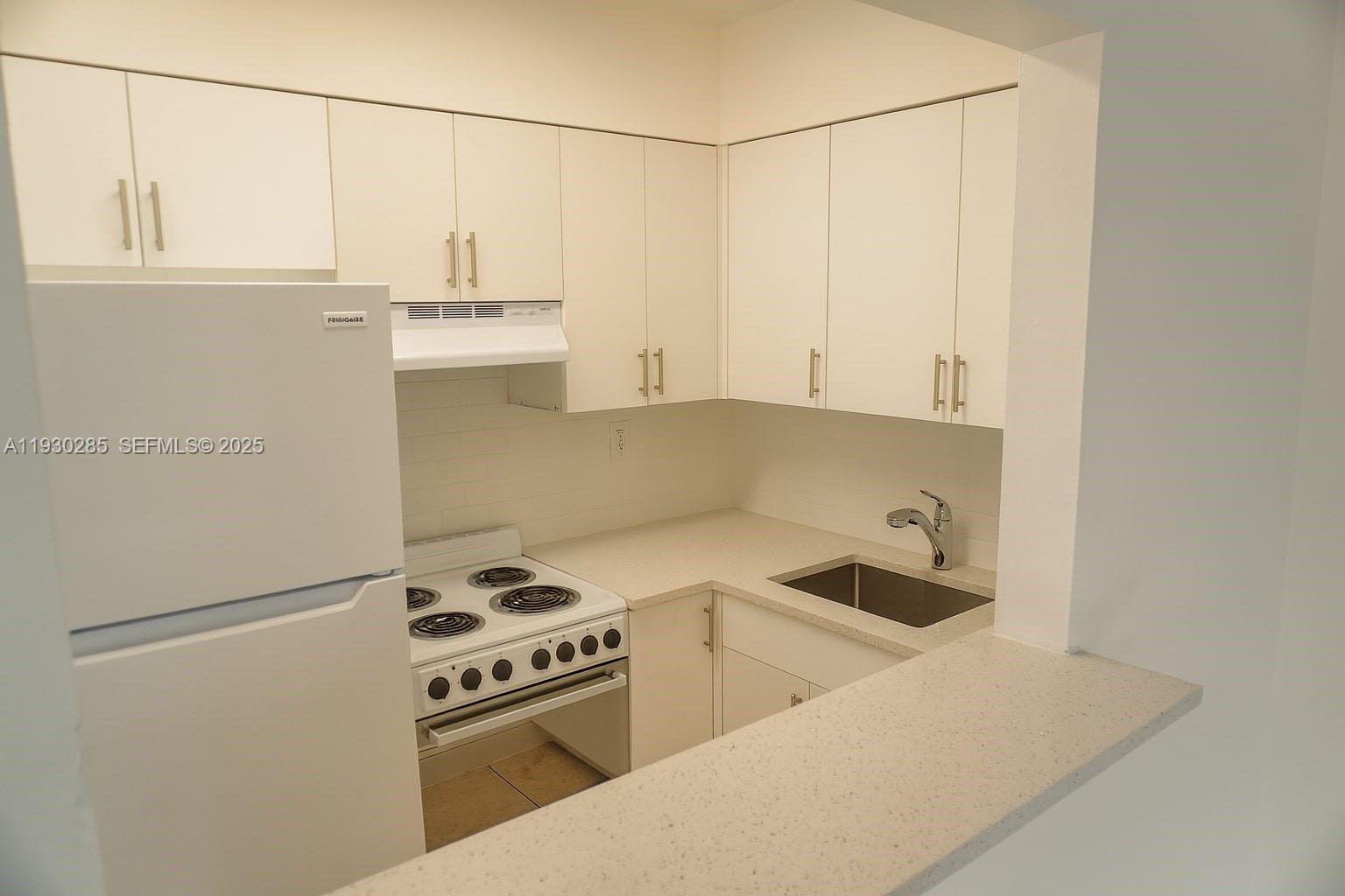 749 Southeast 15th Street, Unit 10 Fort Lauderdale, FL 33316 - Photo 4 of 16 a kitchen with appliances cabinets and a sink