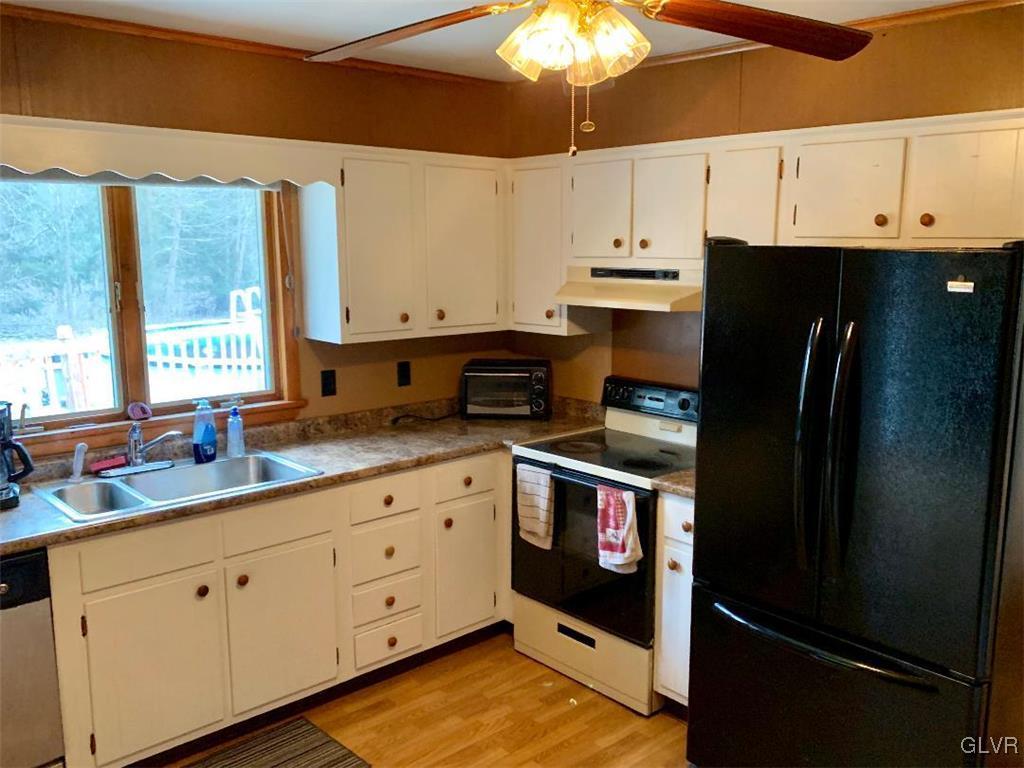 1330 Keller Road Wind Gap, PA 18091 - Photo 5 of 14 a kitchen with stainless steel appliances white cabinets and a refrigerator