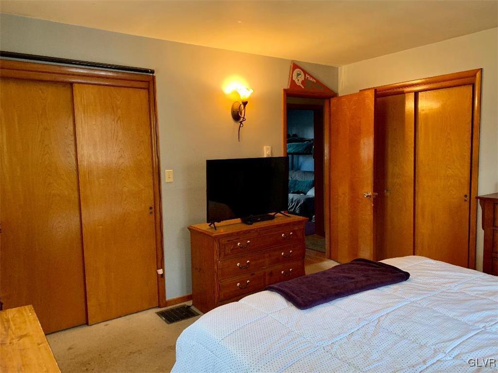 1330 Keller Road Wind Gap, PA 18091 - Photo 8 of 14 a bedroom with a bed and a flat tv screen