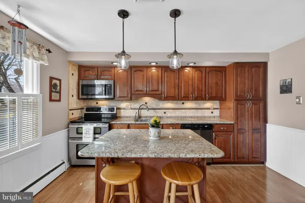 a dining room with furniture a chandelier and wooden floor