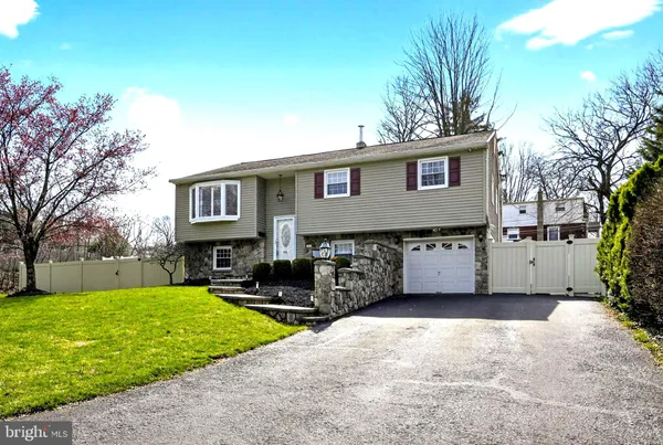 a view of a house with a yard and trees